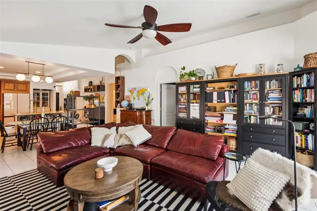 a living room with furniture a rug and a book shelf