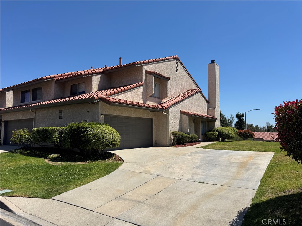 19133 Index Street, Unit 1 Porter Ranch, CA 91326 - Photo 2 of 24 a front view of a house with a garden