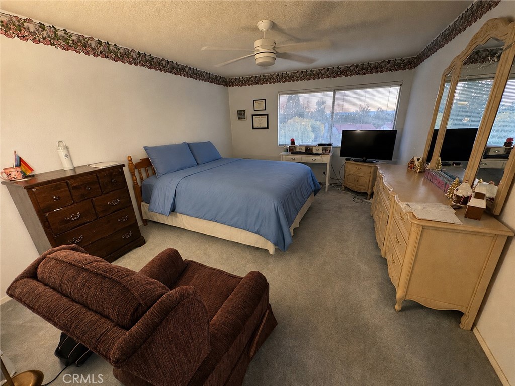 19133 Index Street, Unit 1 Porter Ranch, CA 91326 - Photo 10 of 24 a bedroom with furniture and a flat screen tv