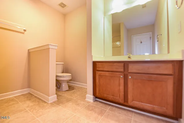 a bathroom with a sink a toilet and mirror