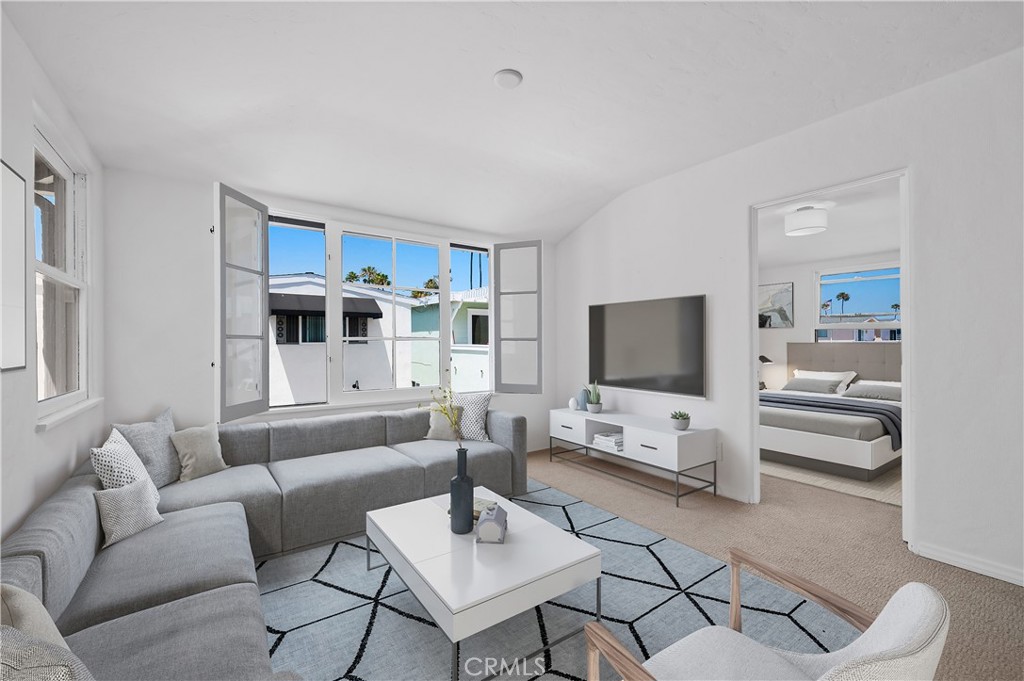 1708 West Oceanfront, Unit B Newport Beach, CA 92663 - Photo 5 of 14 a living room with furniture and a flat screen tv