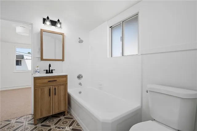 a bathroom with a sink a toilet and bathtub