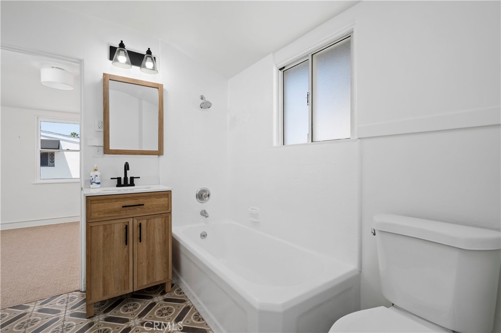 1708 West Oceanfront, Unit B Newport Beach, CA 92663 - Photo 7 of 14 a bathroom with a sink a toilet and bathtub