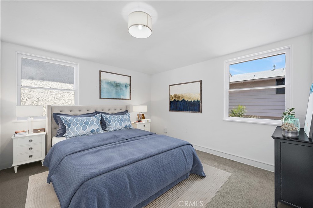 1708 West Oceanfront, Unit B Newport Beach, CA 92663 - Photo 8 of 14 a bedroom with a bed and a painting on the wall