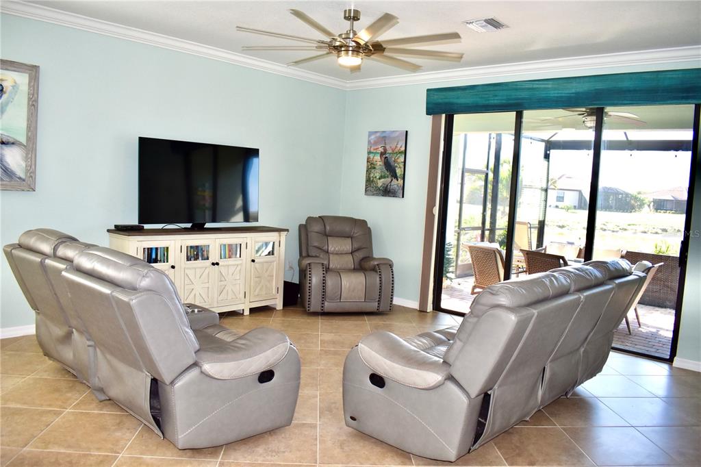 12675 Richezza Drive Venice, FL 34293 - Photo 12 of 60 a living room with furniture and a flat screen tv