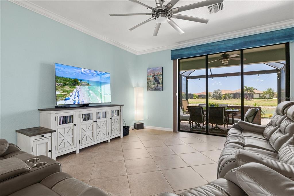 12675 Richezza Drive Venice, FL 34293 - Photo 13 of 60 a living room with furniture and a flat screen tv