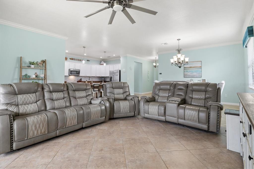 12675 Richezza Drive Venice, FL 34293 - Photo 14 of 60 a living room with furniture and a chandelier