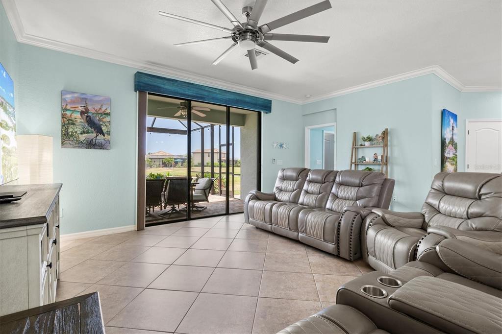 12675 Richezza Drive Venice, FL 34293 - Photo 15 of 60 a living room with furniture and a floor to ceiling window