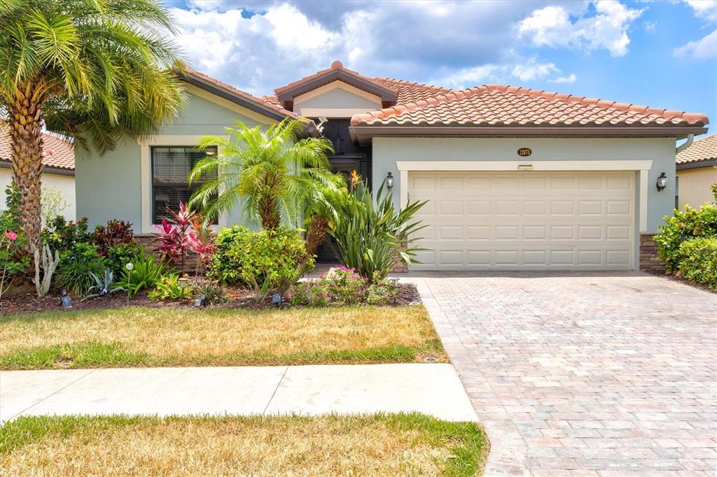 12675 Richezza Drive Venice, FL 34293 - Photo 2 of 60 a front view of a house with a garden