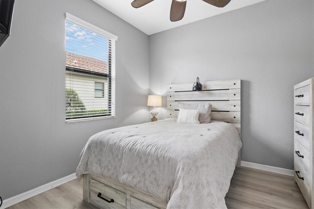 12675 Richezza Drive Venice, FL 34293 - Photo 22 of 60 a bedroom with a bed and wooden floor