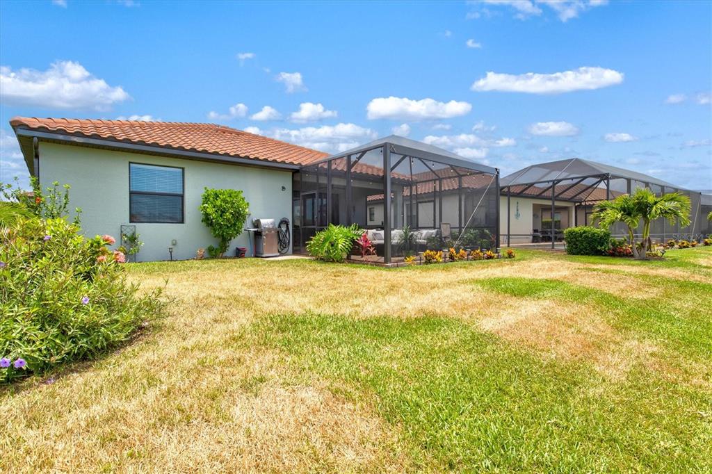 12675 Richezza Drive Venice, FL 34293 - Photo 33 of 60 a front view of a house with a yard