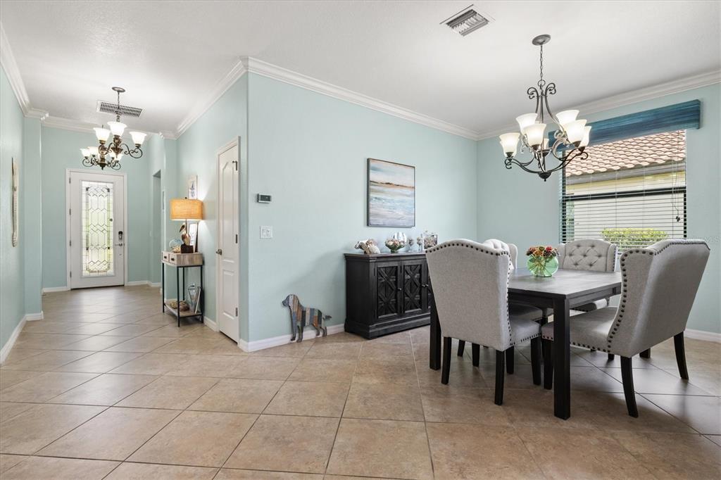 12675 Richezza Drive Venice, FL 34293 - Photo 7 of 60 a view of a dining room with furniture and chandelier