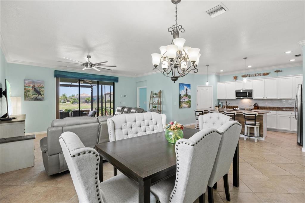 12675 Richezza Drive Venice, FL 34293 - Photo 8 of 60 a view of a dining room with furniture a livingroom and chandelier