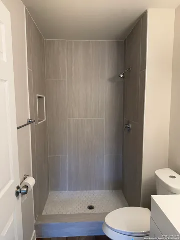 a bathroom with a toilet and a shower