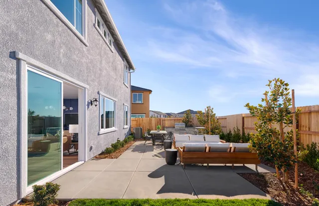 a view of a patio with couches and potted plants