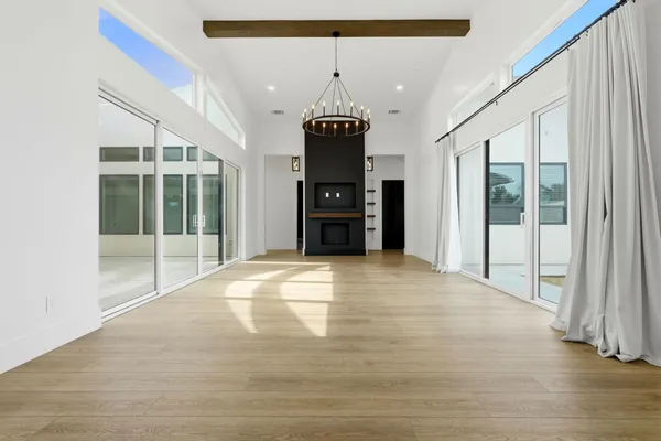 a kitchen with kitchen island white cabinets and black stainless steel appliances