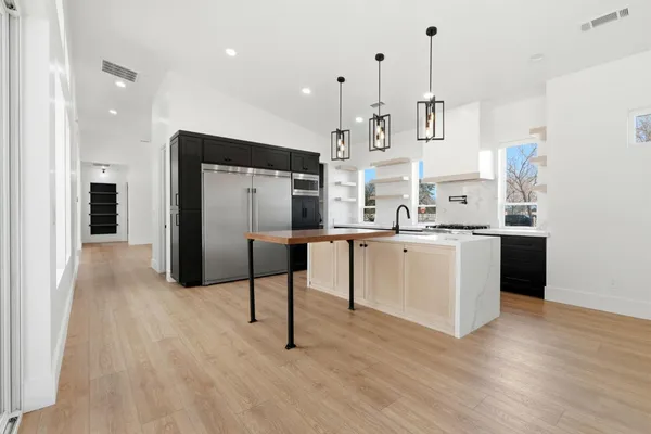 a kitchen with a sink and a refrigerator
