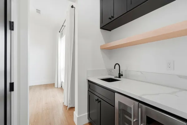a bathroom with a double vanity sink a mirror and a bathtub