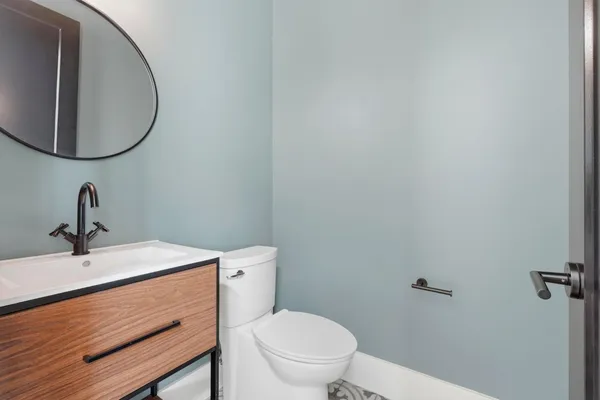 a bathroom with double sink a mirror and shower