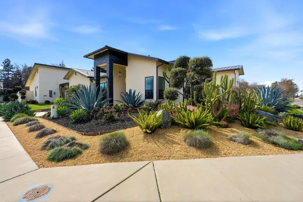 a front view of house with yard and outdoor seating