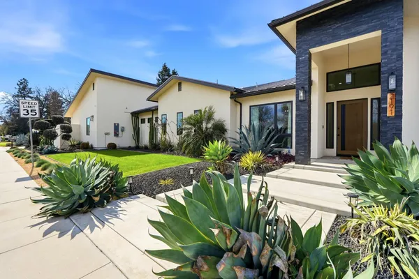 a kitchen with stainless steel appliances kitchen island hardwood floor sink and stove