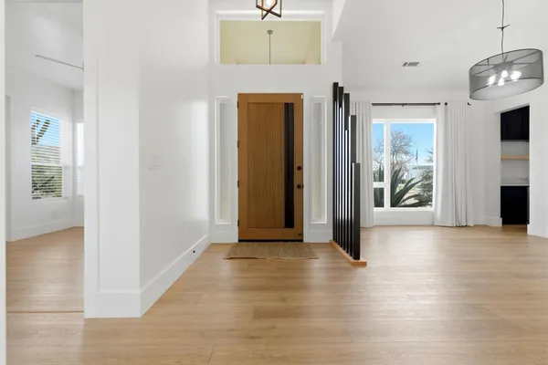 a view of a kitchen with a sink and a refrigerator