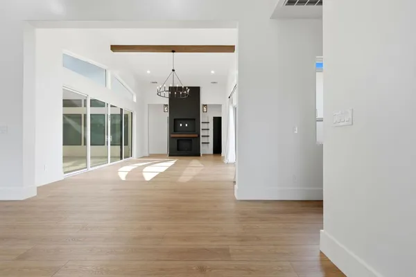 a large white kitchen with a large window a sink and stainless steel appliances