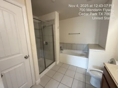 a bathroom with a bathtub and a shower