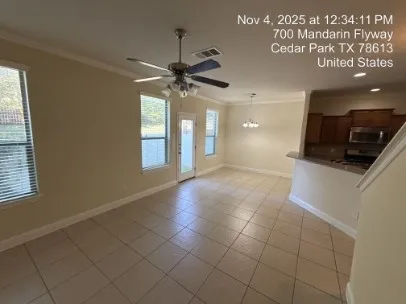 a view of a kitchen with a sink and a chandelier fan