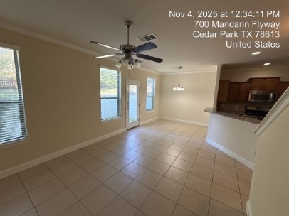 700 Mandarin Flyway, Unit 502 Cedar Park, TX 78613 - Photo 6 of 25 a view of a kitchen with a sink and a chandelier fan
