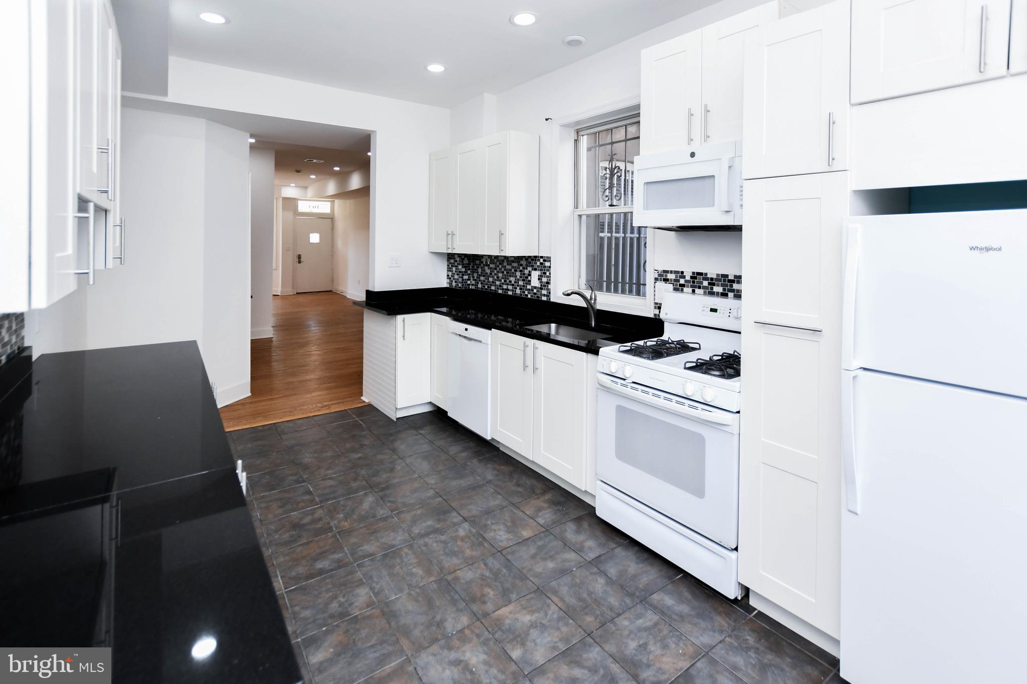 104 R Street Northeast, Unit A Washington, DC 20002 - Photo 17 of 43 a kitchen with stainless steel appliances a refrigerator sink and white cabinets