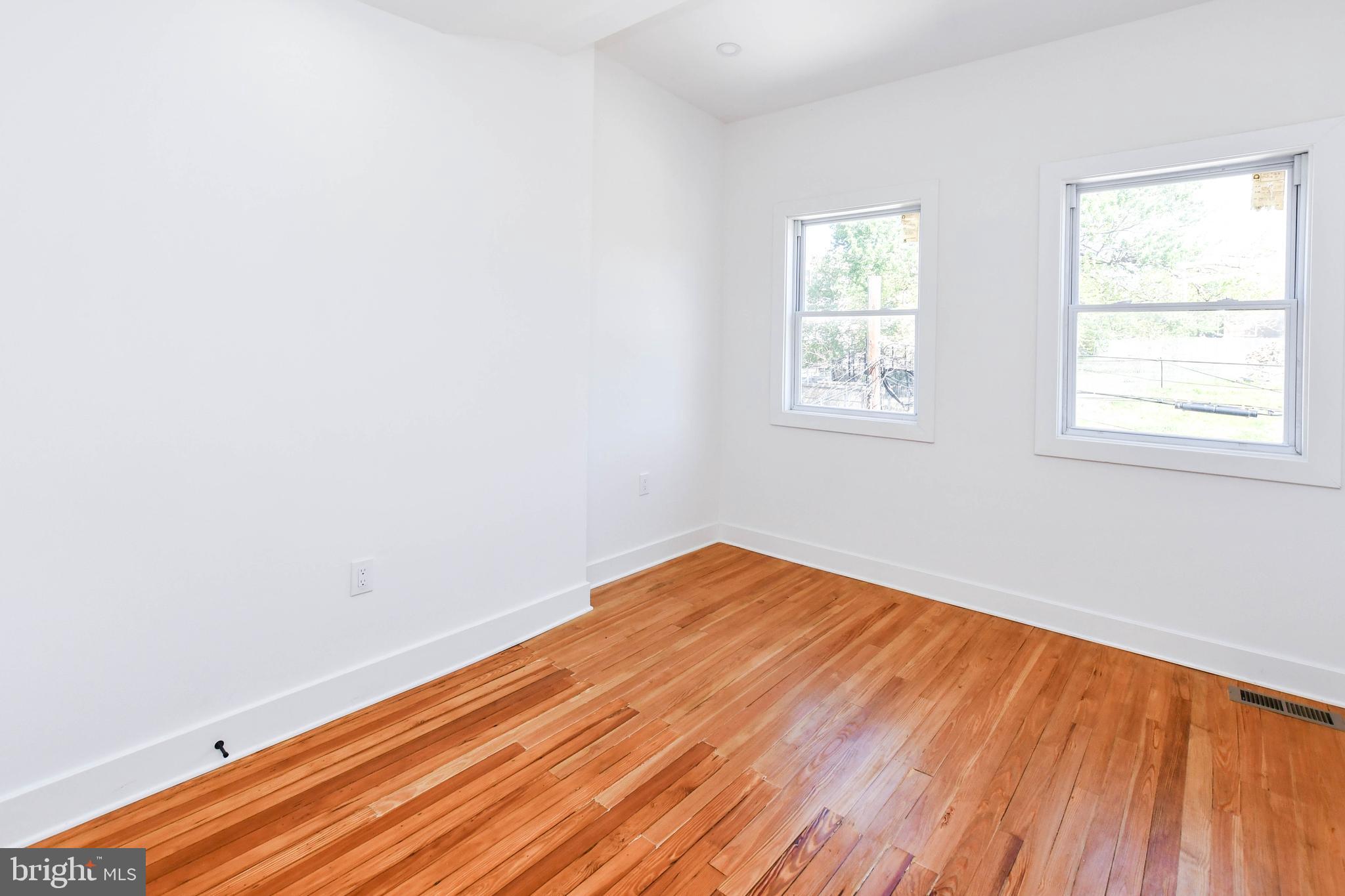 104 R Street Northeast, Unit A Washington, DC 20002 - Photo 22 of 43 an empty room with wooden floor and windows