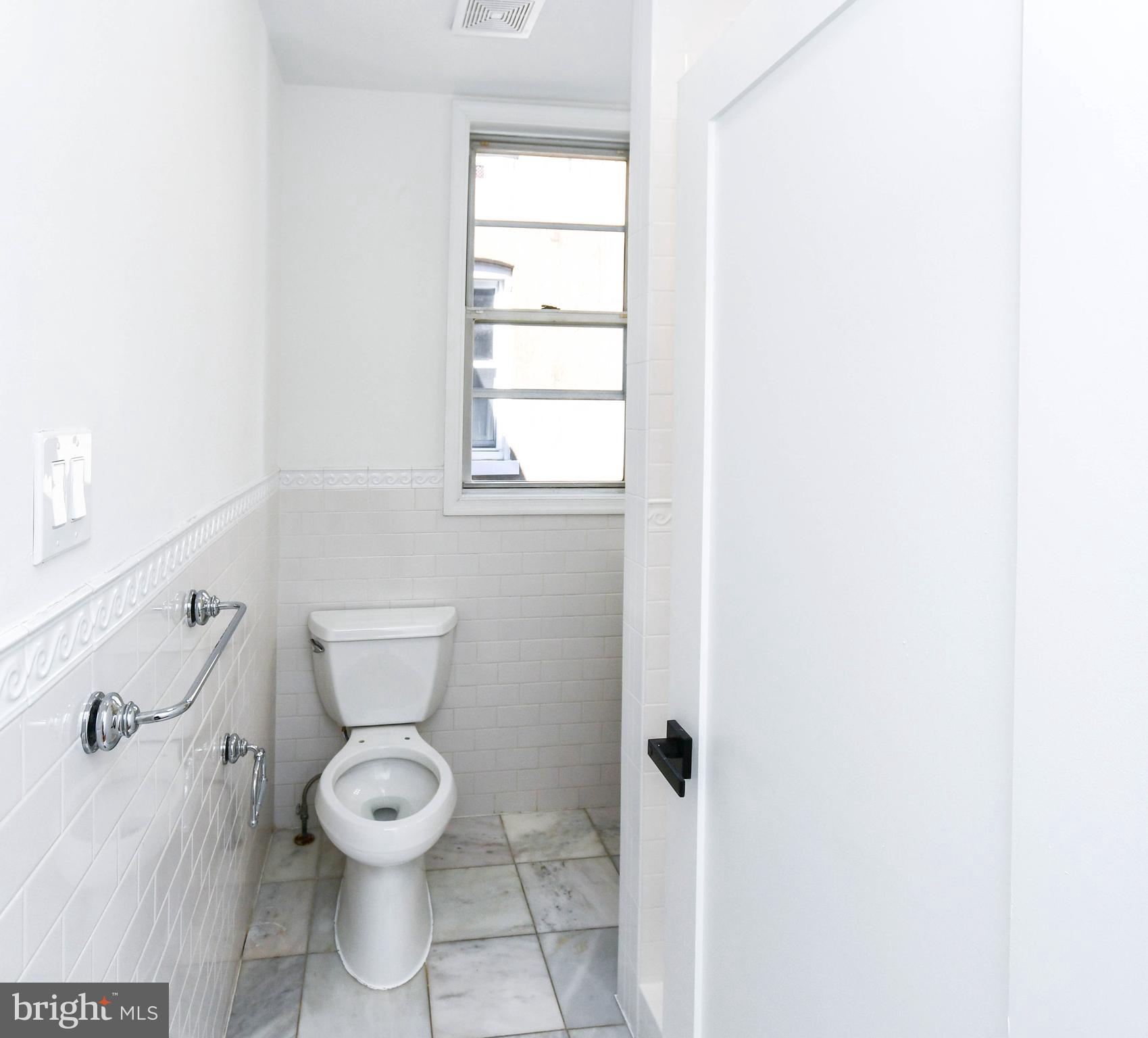 104 R Street Northeast, Unit A Washington, DC 20002 - Photo 25 of 43 a white toilet sitting next to a bathroom sink