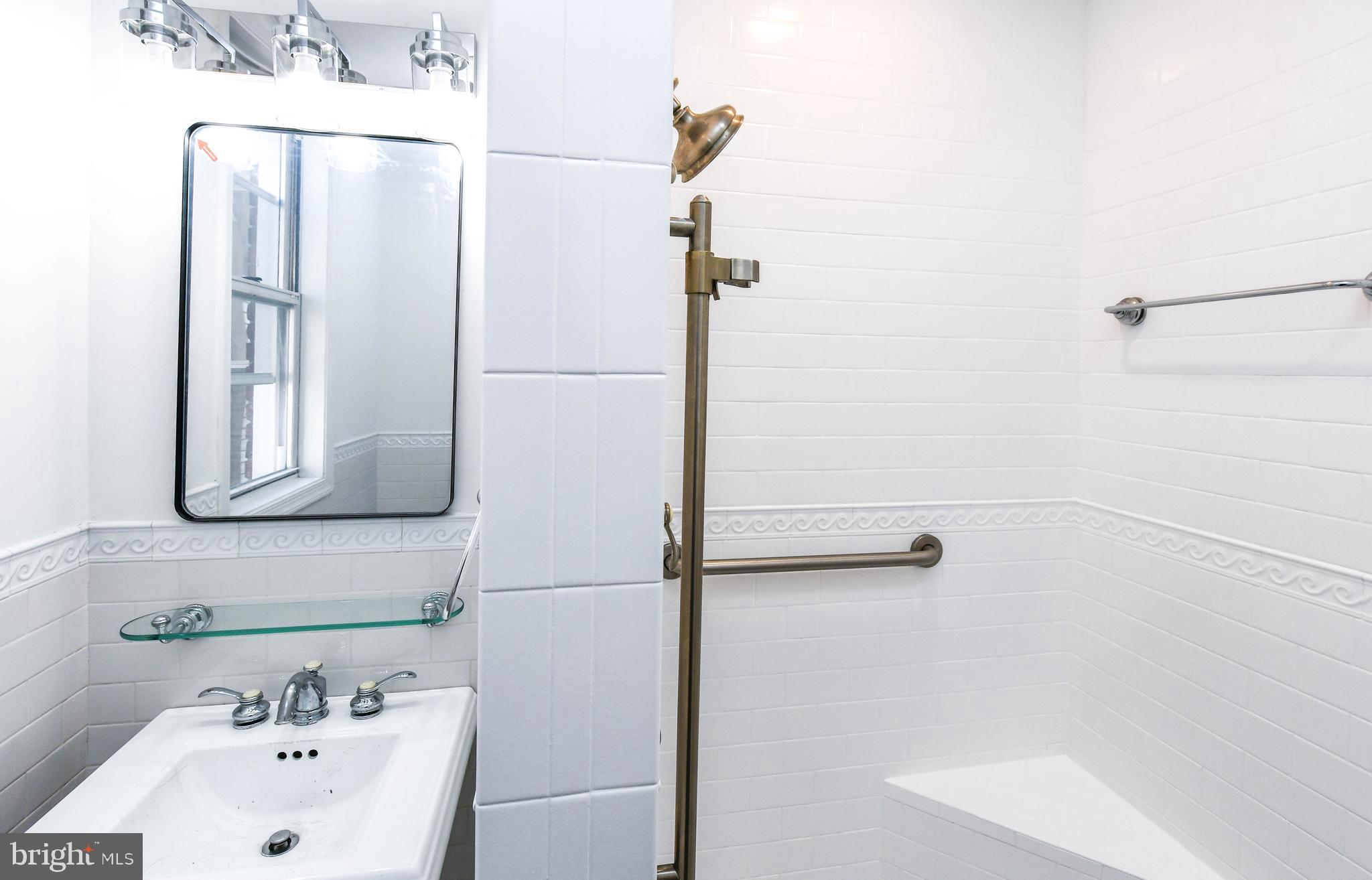 104 R Street Northeast, Unit A Washington, DC 20002 - Photo 27 of 43 a bathroom with a sink and a shower