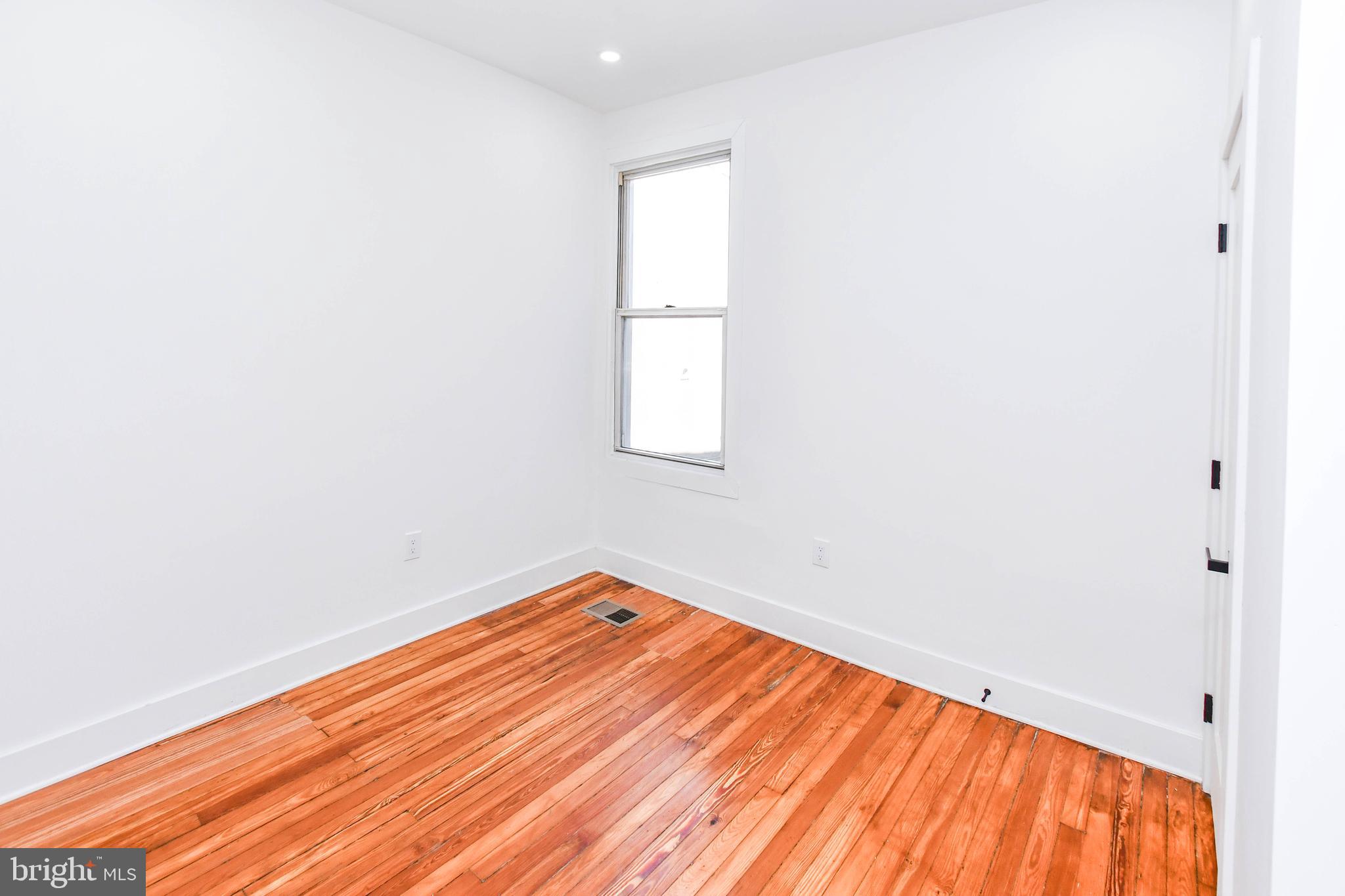 104 R Street Northeast, Unit A Washington, DC 20002 - Photo 28 of 43 an empty room with wooden floor and windows