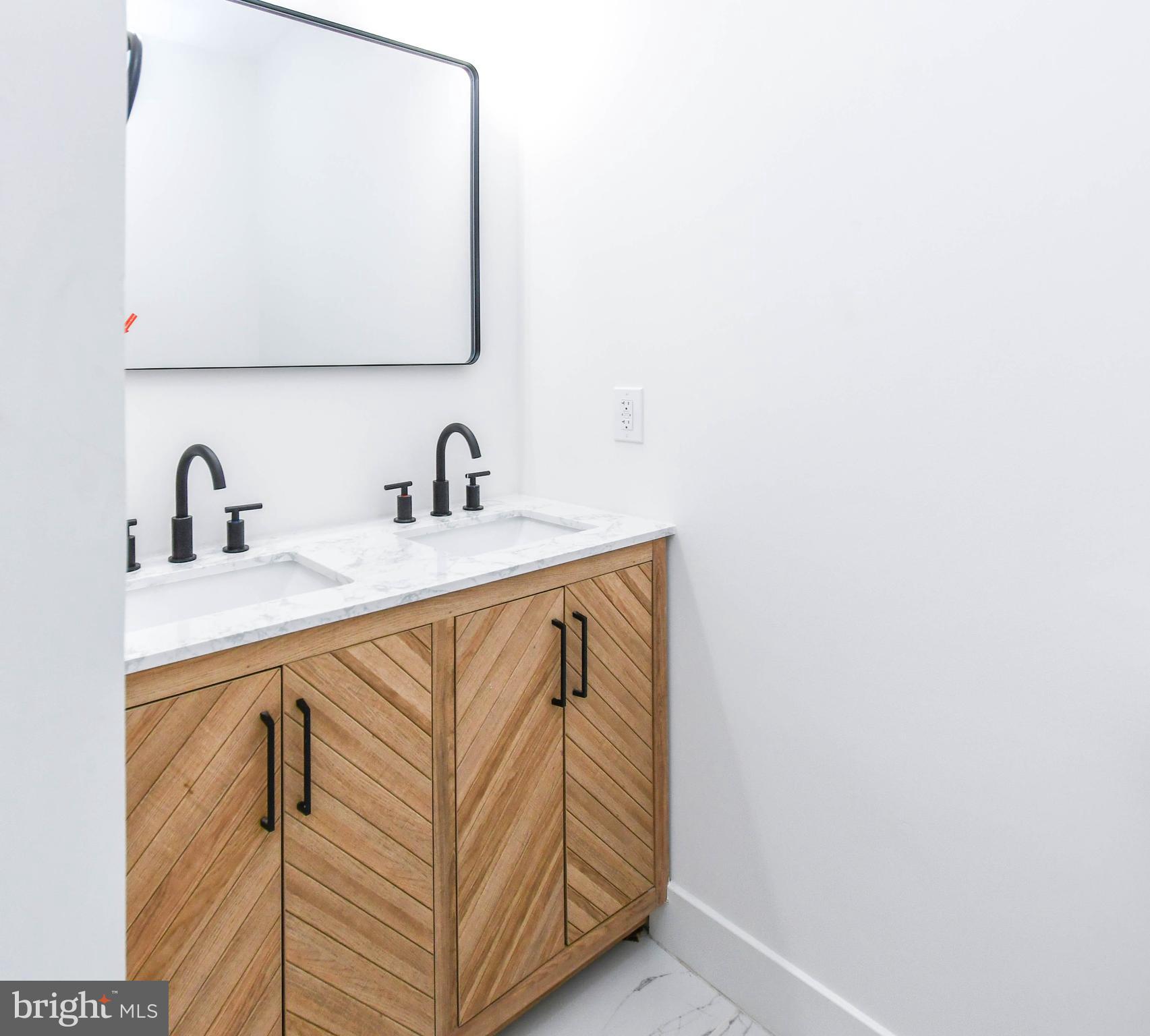104 R Street Northeast, Unit A Washington, DC 20002 - Photo 32 of 43 a bathroom with a sink and a mirror