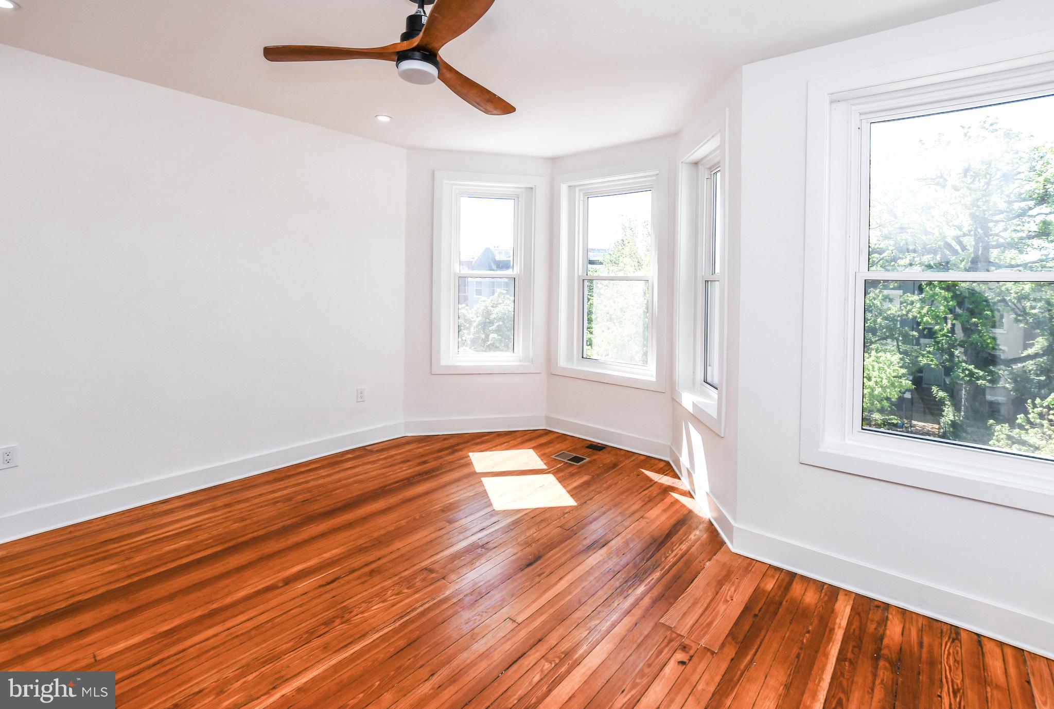 104 R Street Northeast, Unit A Washington, DC 20002 - Photo 35 of 43 a view of empty room with wooden floor and fan