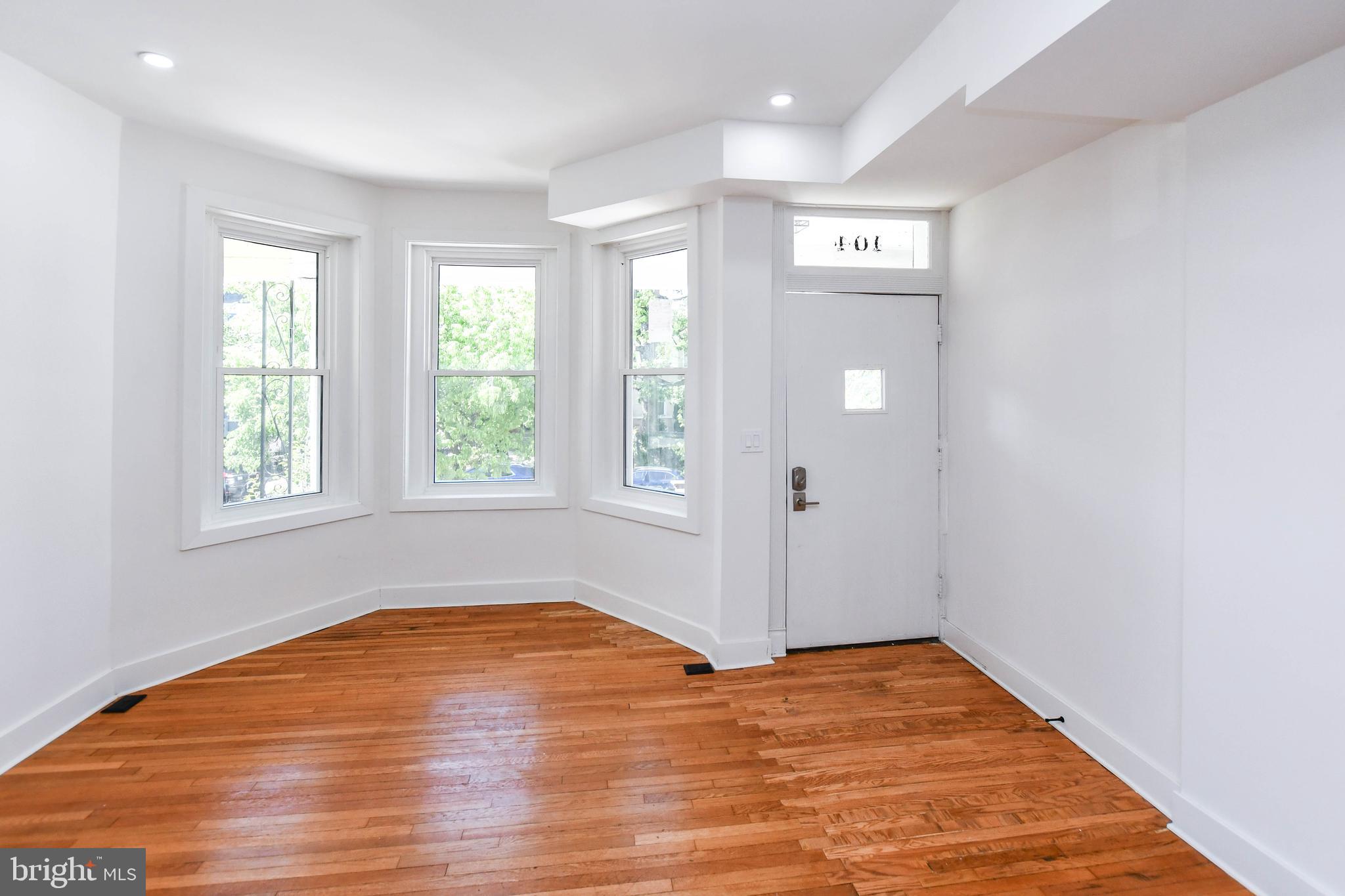 104 R Street Northeast, Unit A Washington, DC 20002 - Photo 6 of 43 an empty room with wooden floor and windows