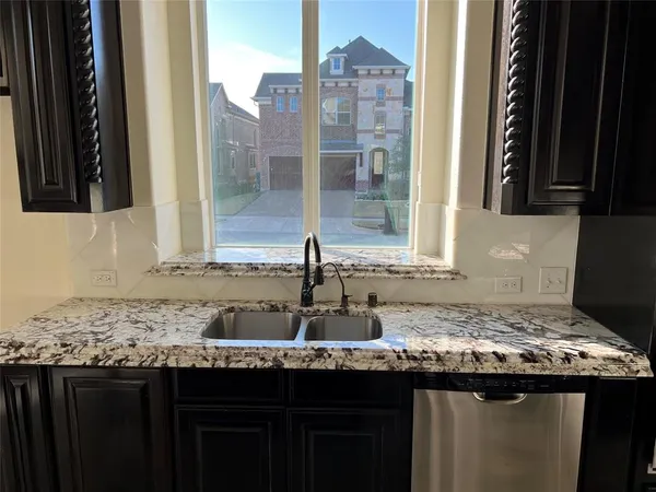 a kitchen with a sink and a wooden cabinets