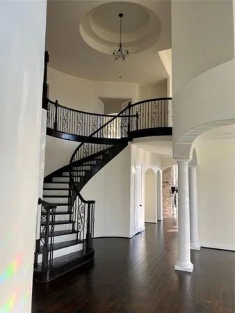 a view of entryway and hall with wooden floor