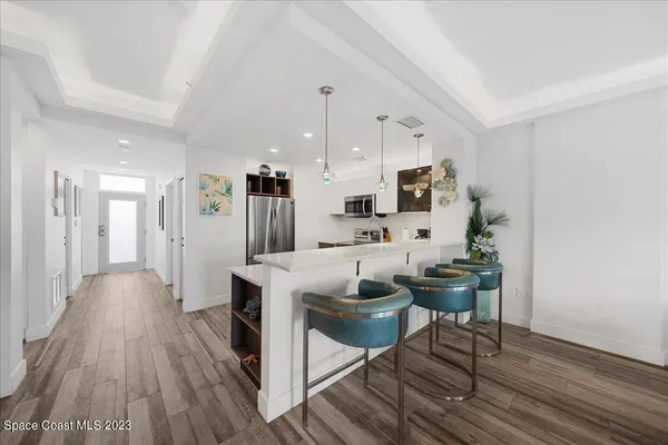 a living room with furniture a wooden floor and a fireplace
