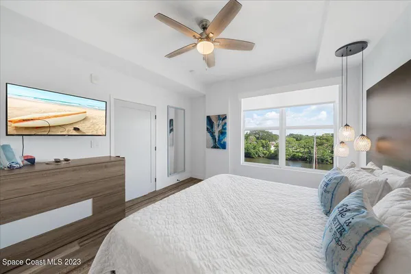 a bathroom with a granite countertop sink a toilet a mirror and shower
