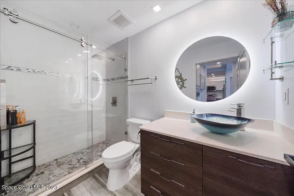 a view of a lake with couches in patio