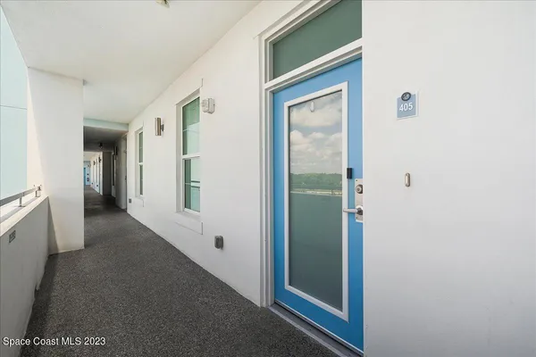 a view of a hallway with an entryway door