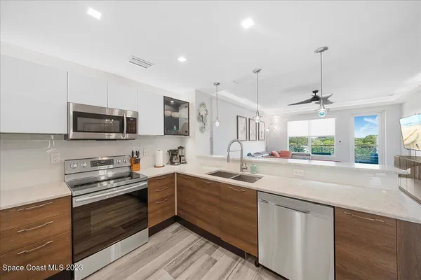 a kitchen with a sink stove and microwave