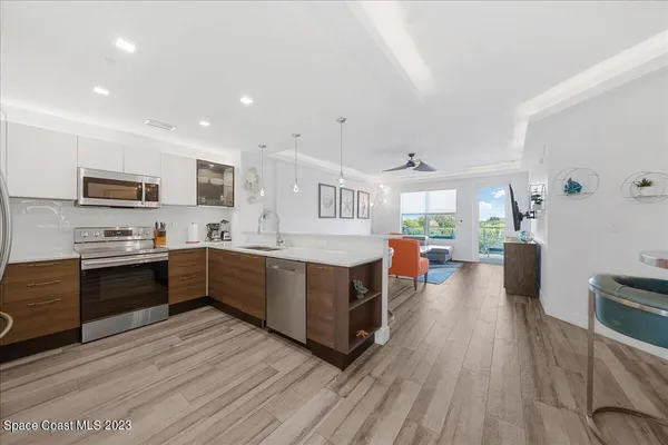 a large kitchen with a large counter top appliances and cabinets