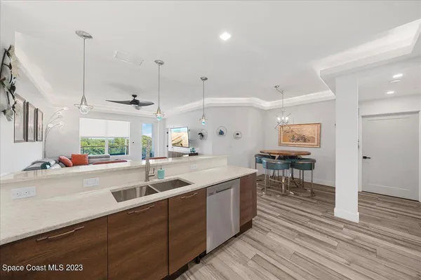 a kitchen with stainless steel appliances granite countertop a sink a stove and a wooden floors