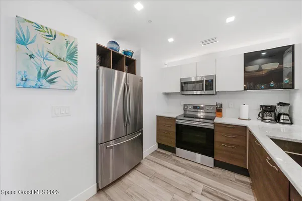 a kitchen with stainless steel appliances granite countertop a refrigerator stove top oven and sink