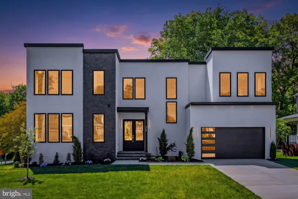 a large kitchen with stainless steel appliances a large counter top a sink a stove and a refrigerator