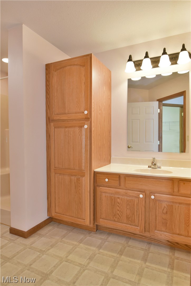 2033 East River Road, Unit 11 Newton Falls, OH 44444 - Photo 25 of 35 Bathroom with vanity, light tile flooring, and mirror
